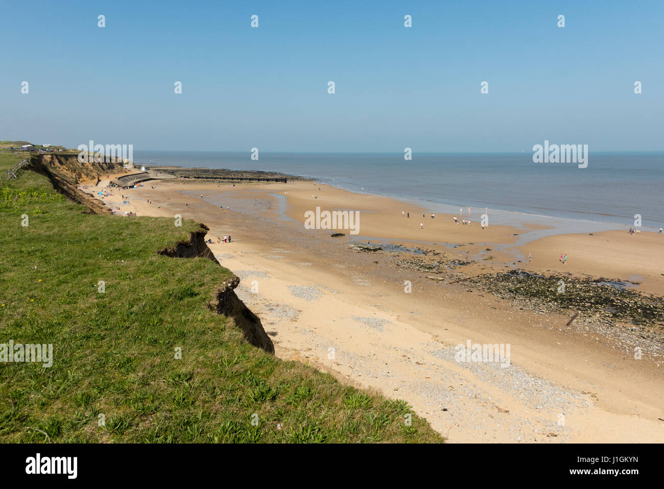 People on the wide open beach on the North Norfolk Coast UK on a sunny day near West Runton Stock Photo