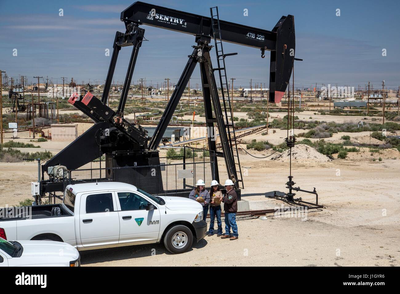 A federal Bureau of Land Management team inspects pump jacks in the Kern River Oil Field along the San Joaquin Valley April 11, 2017 in Bakersfield, California. The oil and gas wells that cover the area are on public land leased by the federal government to private industry. Stock Photo