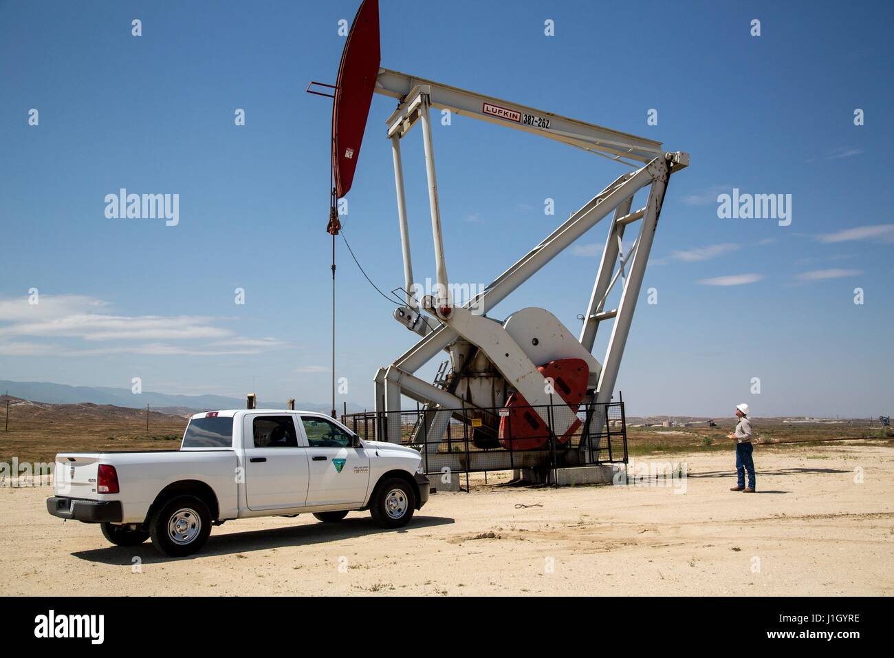 A federal Bureau of Land Management team inspects pump jacks in the Kern River Oil Field along the San Joaquin Valley April 11, 2017 in Bakersfield, California. The oil and gas wells that cover the area are on public land leased by the federal government to private industry. Stock Photo