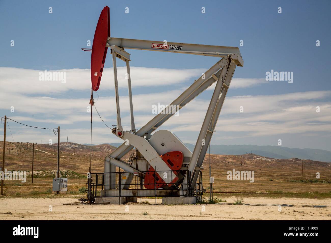 An crude oil pump jack working in the Kern River Oil Field along the San Joaquin Valley April 11, 2017 in Bakersfield, California. The oil and gas wells that cover the area are on public land leased by the federal Bureau of Land Management. Stock Photo