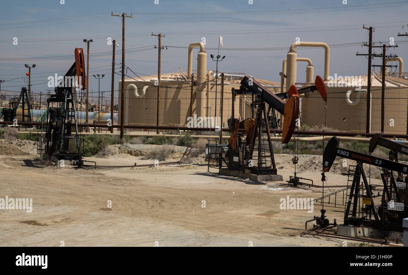 Oil pump jacks and crude oil storage tanks in the Kern River Oil Field along the San Joaquin Valley April 11, 2017 in Bakersfield, California. The oil and gas wells that cover the area are on public land leased by the federal Bureau of Land Management. Stock Photo