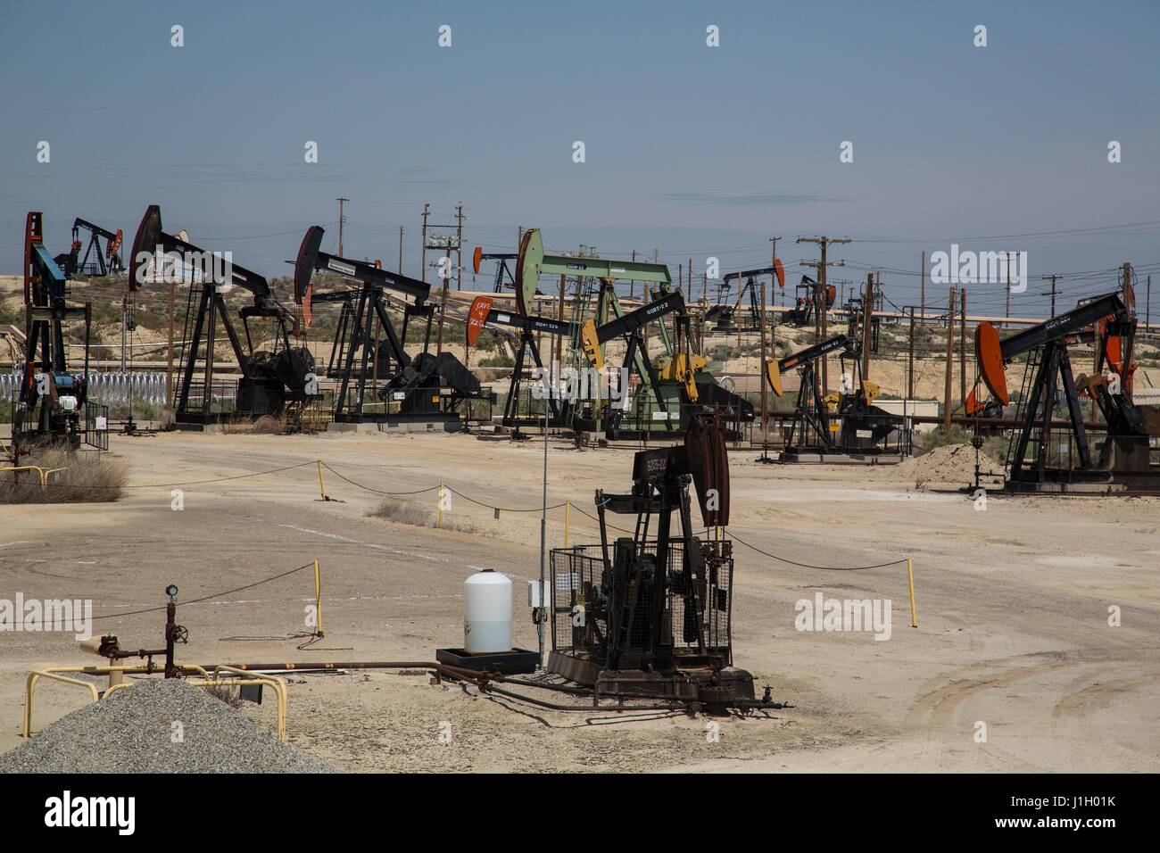 Oil pump jacks cover the ground in the Kern River Oil Field along the San Joaquin Valley April 11, 2017 in Bakersfield, California. The oil and gas wells that cover the area are on public land leased by the federal Bureau of Land Management. Stock Photo