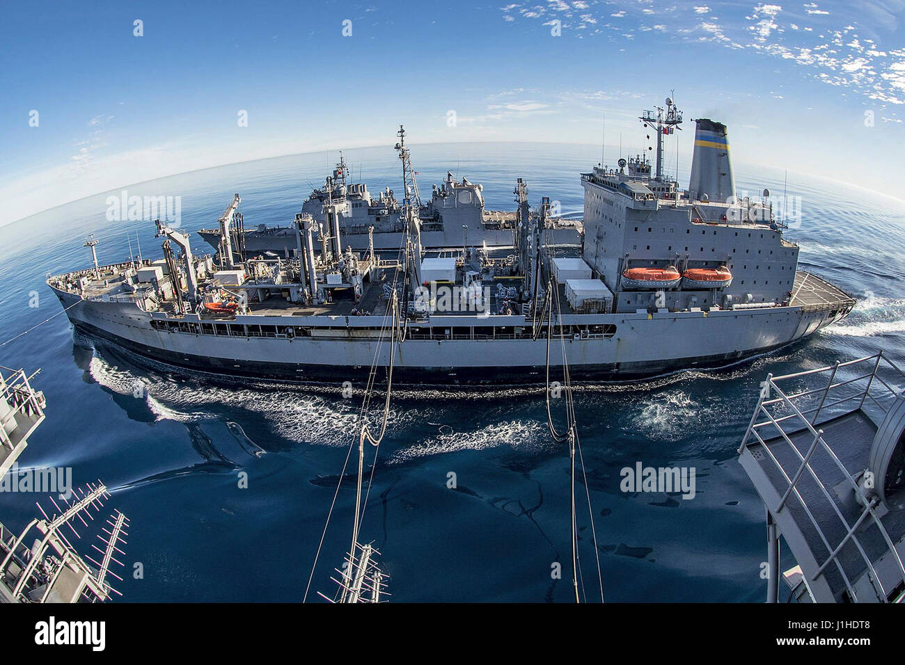 The fleet replenishment oiler USNS Yukon conducts a dual replenishment with the USS Carl Vinson Stock Photo