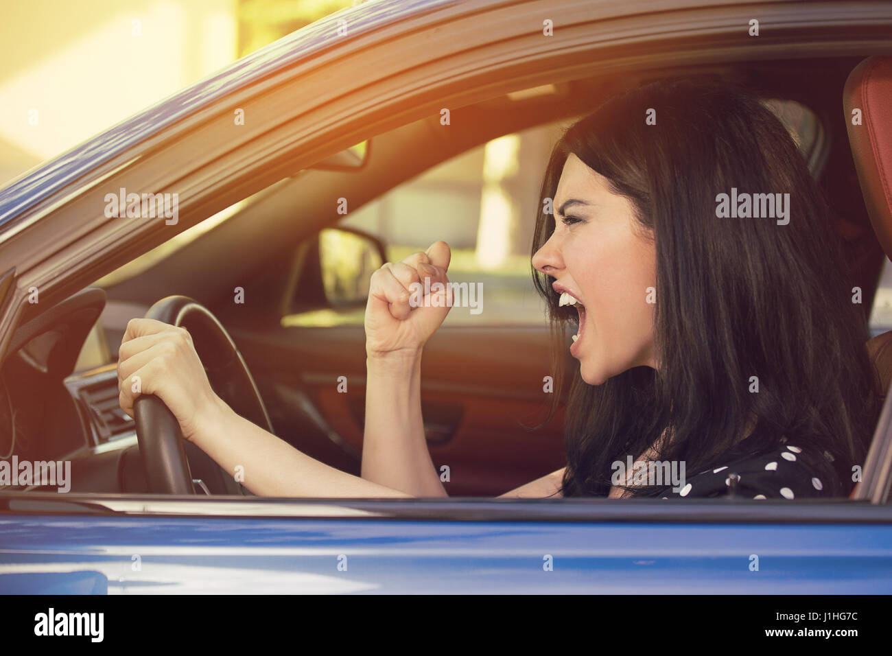 Side profile of an angry young driver. Negative human emotions face expression Stock Photo