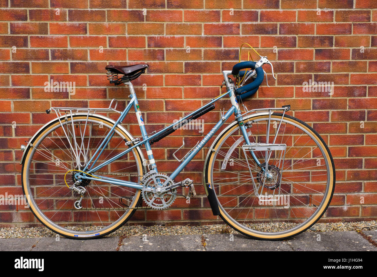 Classic custom built ladies Mercian traditional touring bicycle bike with leather Brookes saddle drop handlebars leaning up against a brick wall. UK Stock Photo Alamy