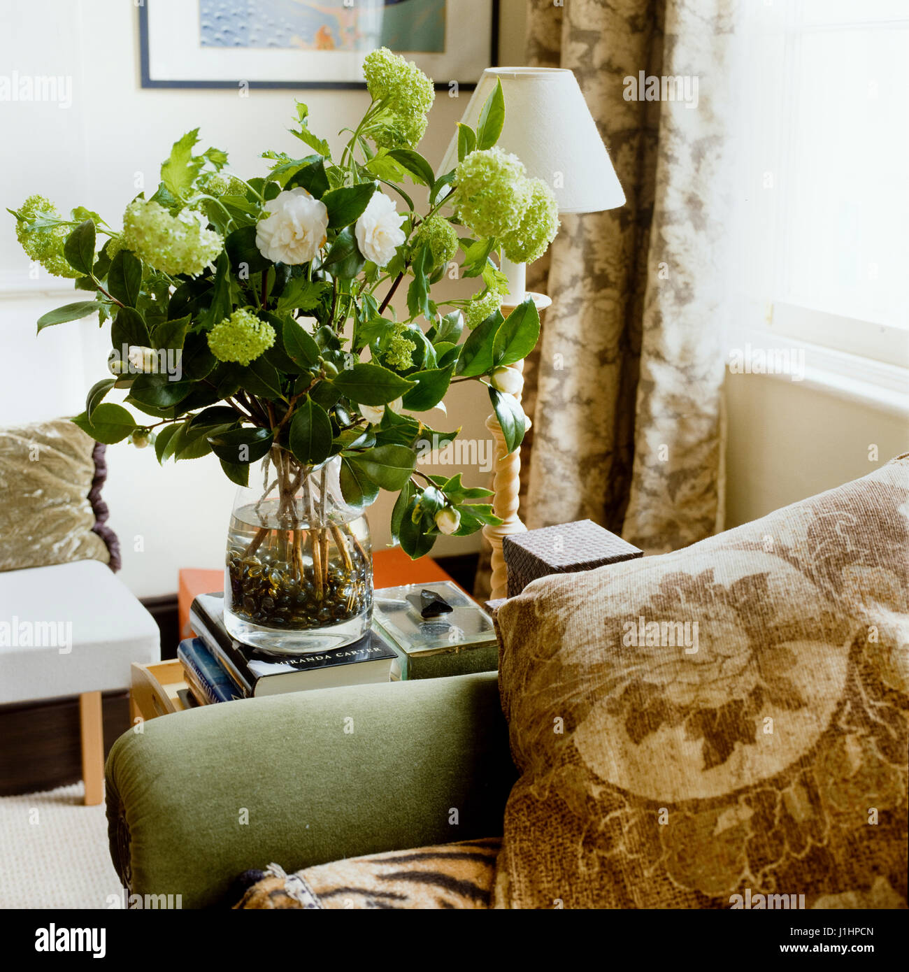 Flowers by sofa. Stock Photo