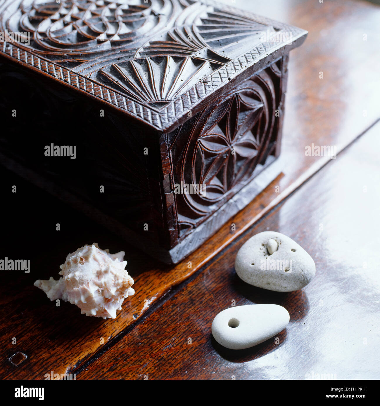 'Carved wooden box, seashell and pebbles.' Stock Photo