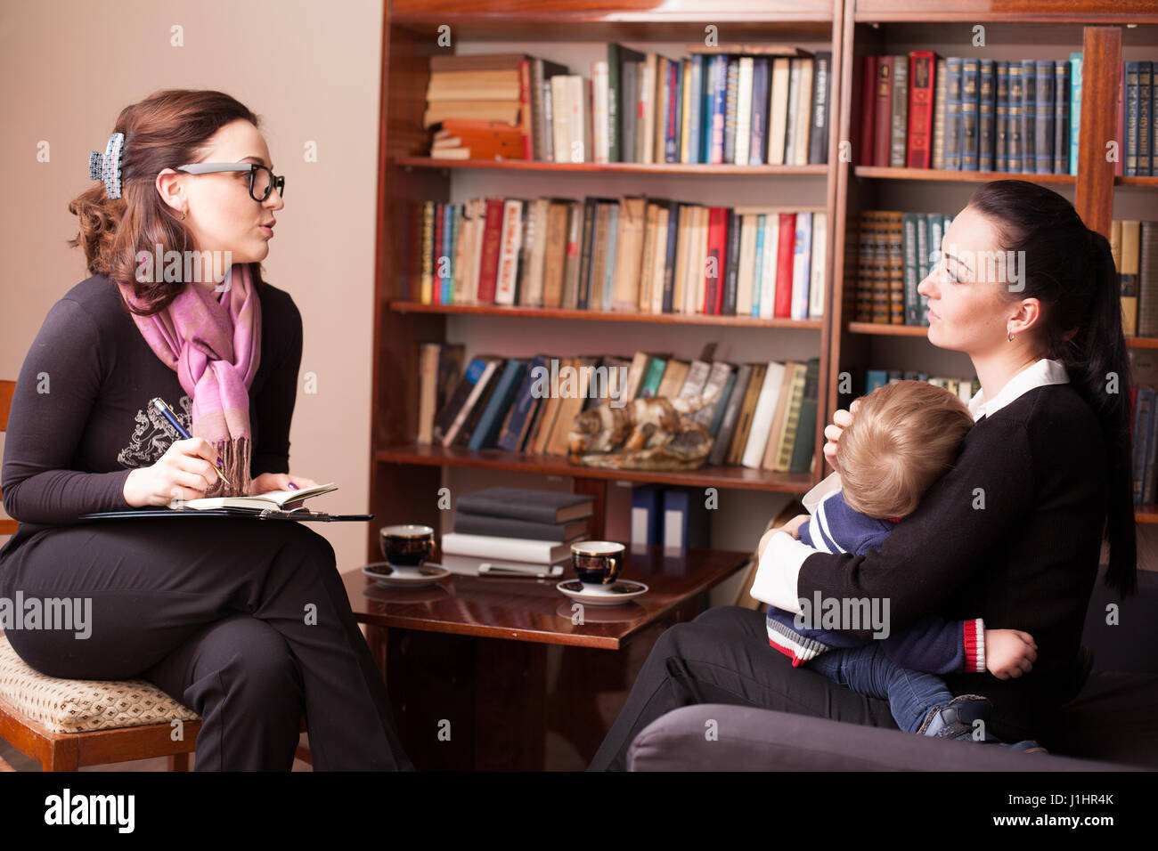 child psychologist advises the mother with child Stock Photo Alamy