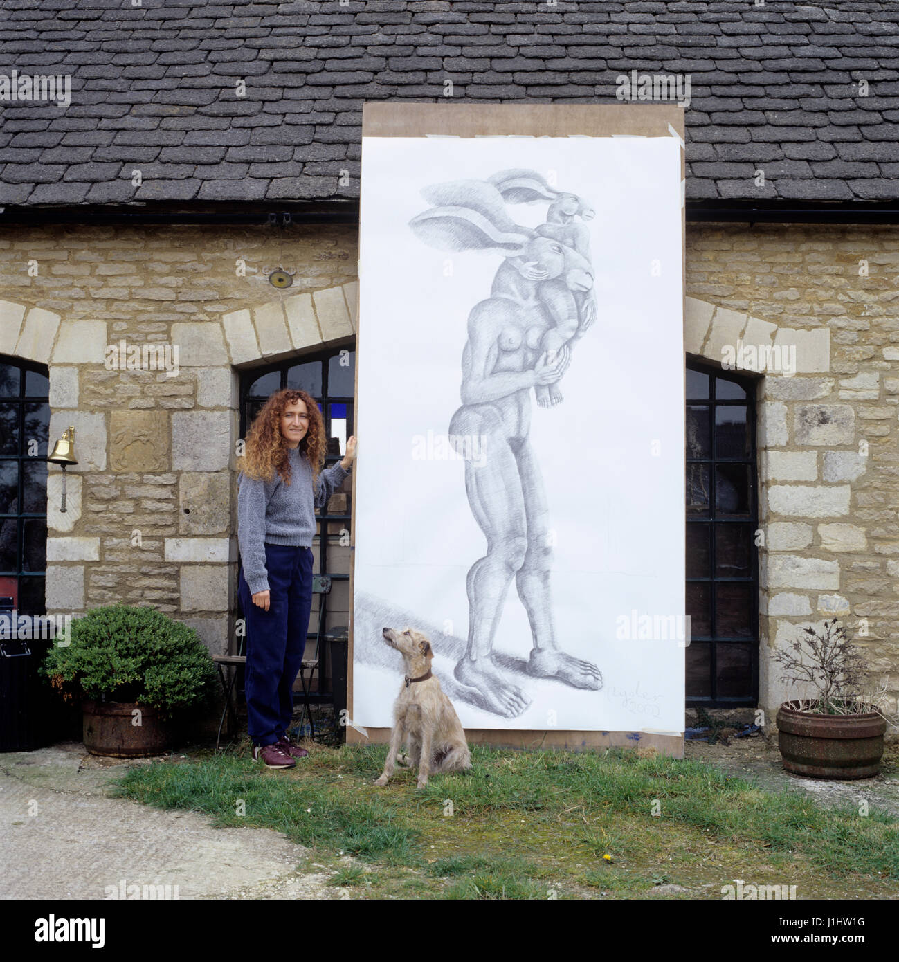 Woman standing by illustration of rabbit-human hybrid. Stock Photo