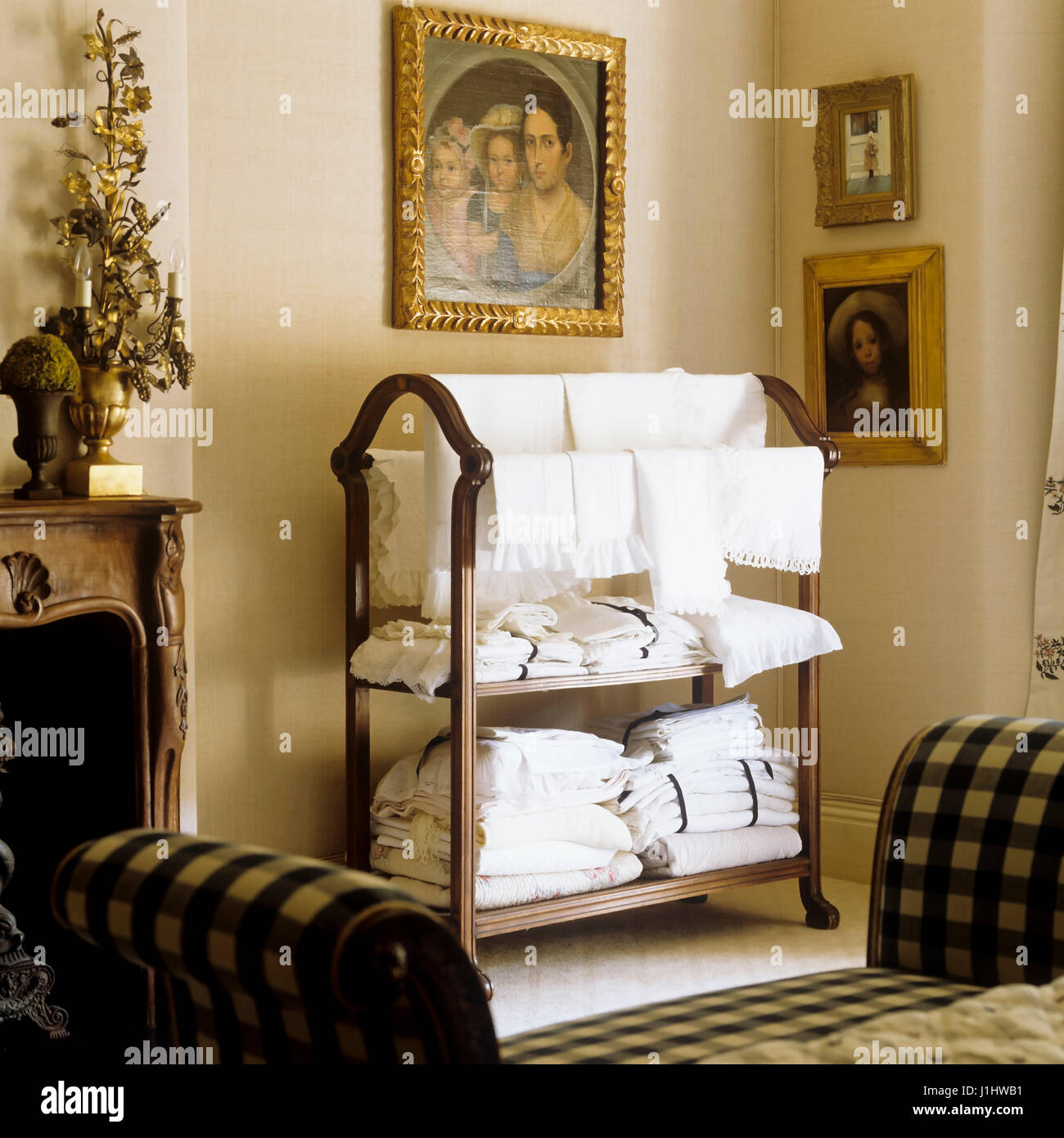 Linen rack and gingham sofa. Stock Photo