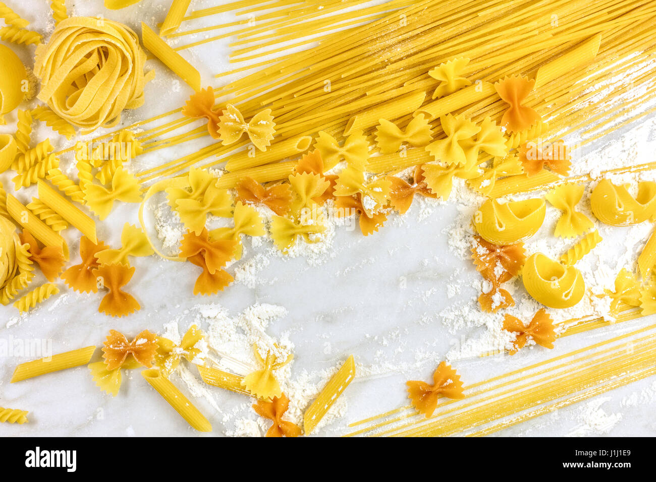 Various types of pasta with flour and copyspace Stock Photo Alamy