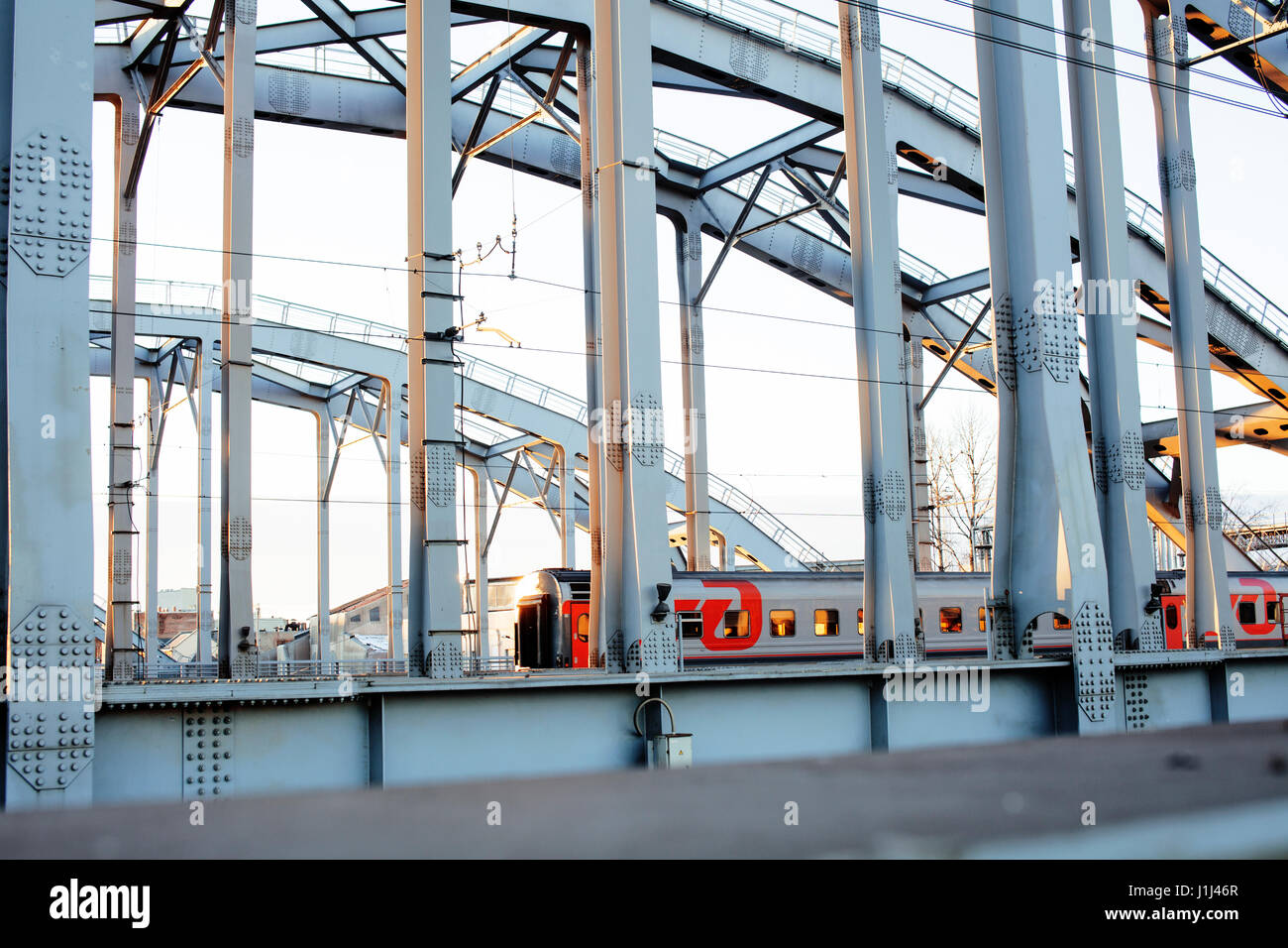 landscape with railway with trains, lot of steel rafters at sunset ...