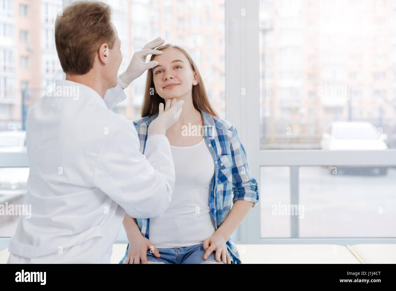 Professional dermatologist exploring patient problems in the clinic Stock Photo