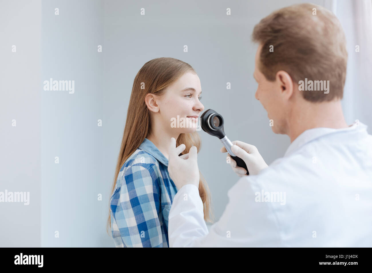 Helpful dermatologist having appointment in the clinic Stock Photo