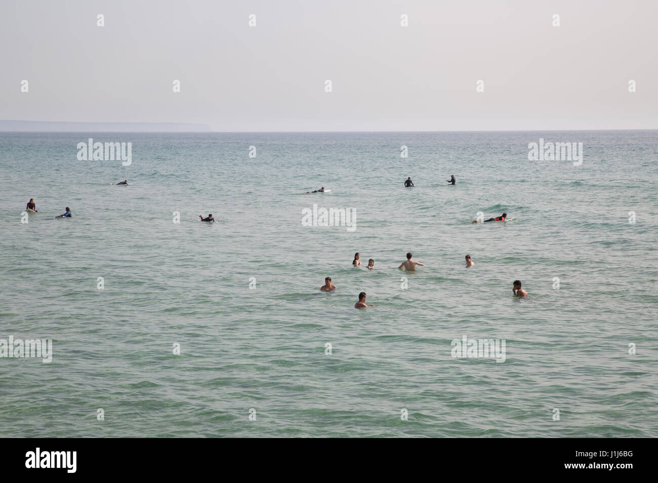 People swimming in the sea at Cascais beach, Lisbon, Portugal. Stock Photo
