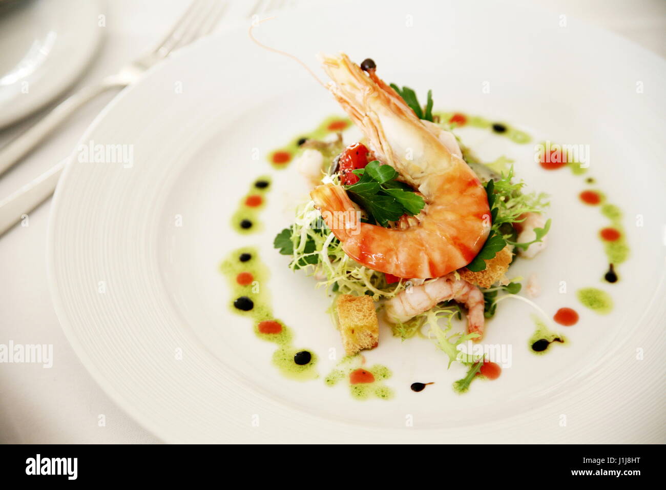 A starter dish of shrimp at a restaurant table Stock Photo