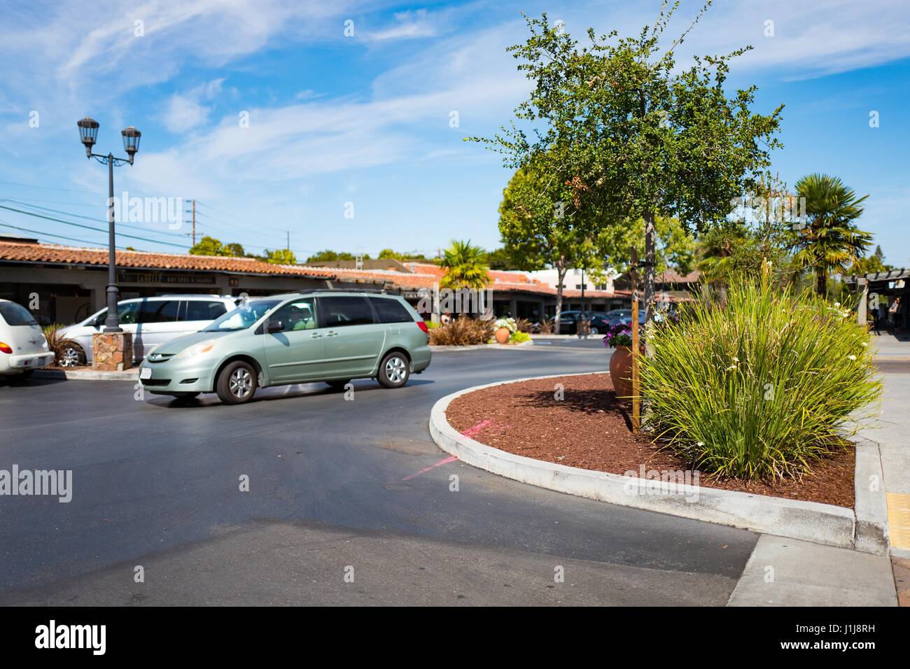 A minivan passes through the parking lot at the Town and Country Shopping Center in the Silicon Valley town of Palo Alto, California, September 3, 2016. Town and Country was among the first shopping centers built in Palo Alto. Stock Photo