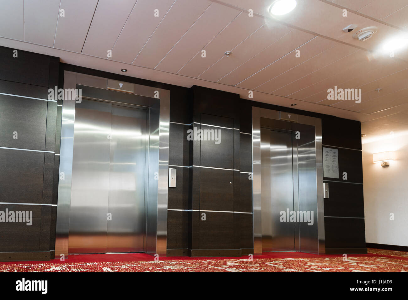 Two elevators with metal doors in the hotel Stock Photo - Alamy