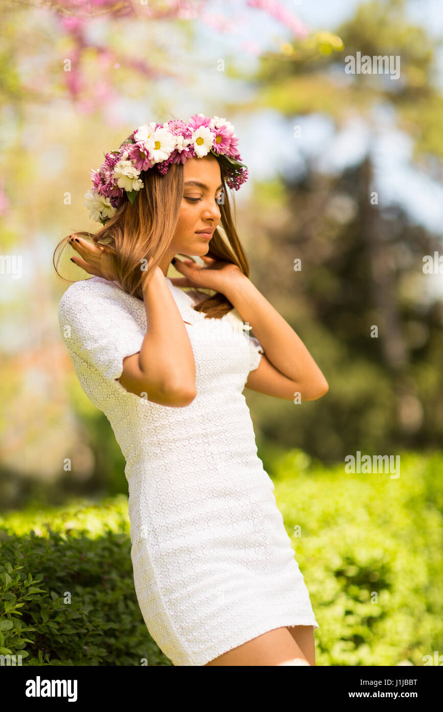 Pretty young woman with flowers in her hair on sunny spring day Stock ...
