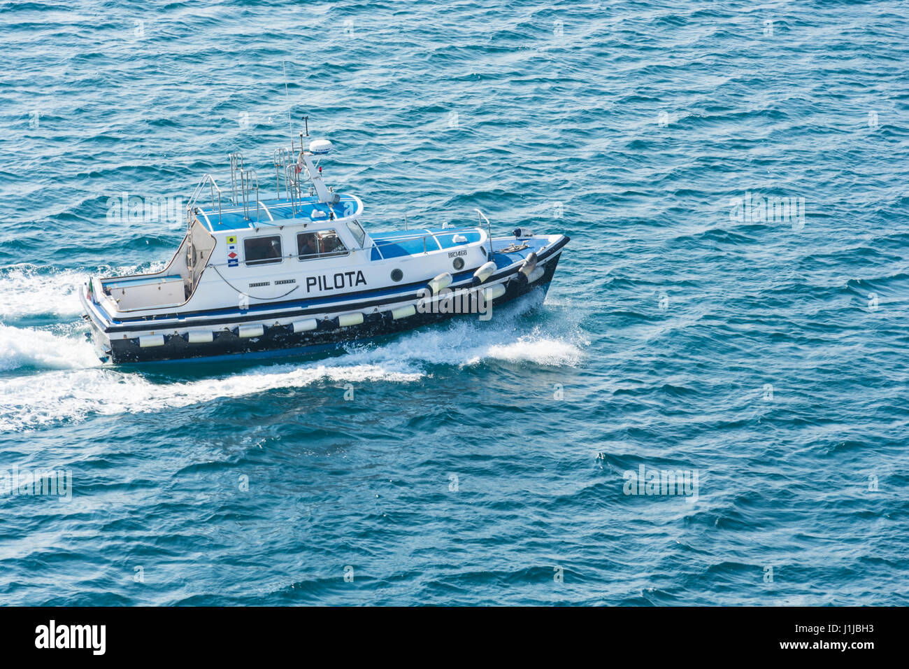 Abstract and conceptual help. A pilot boat in sea. A pilot boat is a type of boat used to transport maritime pilots between land and the inbound or ou Stock Photo