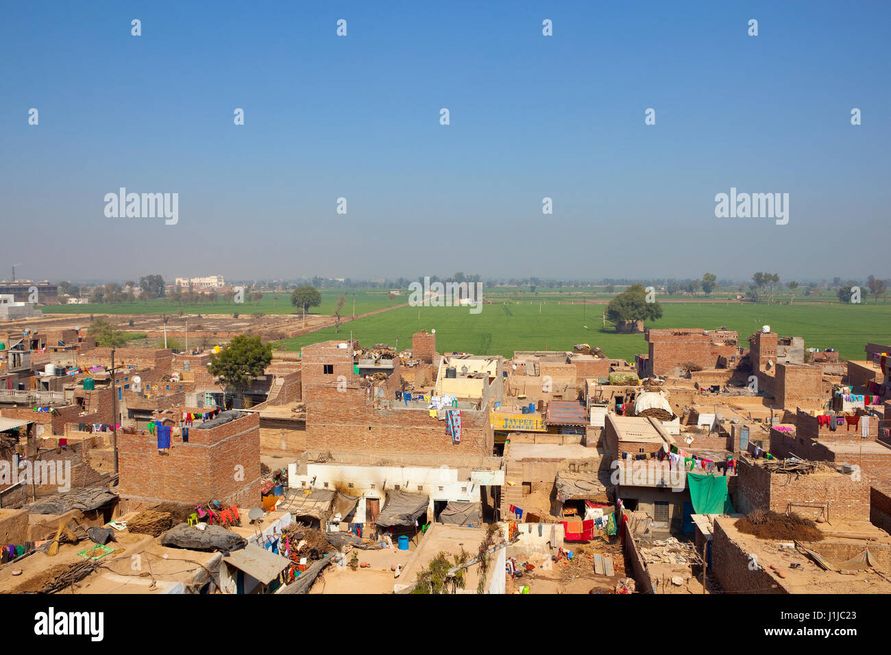 daily life in hanumangarh town viewed from bhatner fort in rajasthan india with the agricultural countryside in the distance under a blue sky Stock Photo