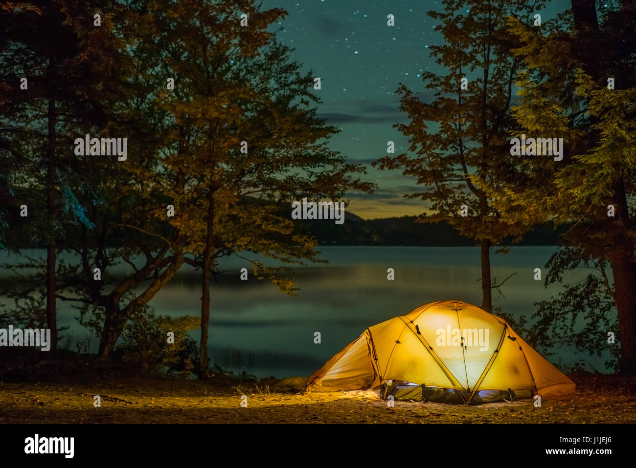 Tent camping in the great outdoors under a starry sky Stock Photo