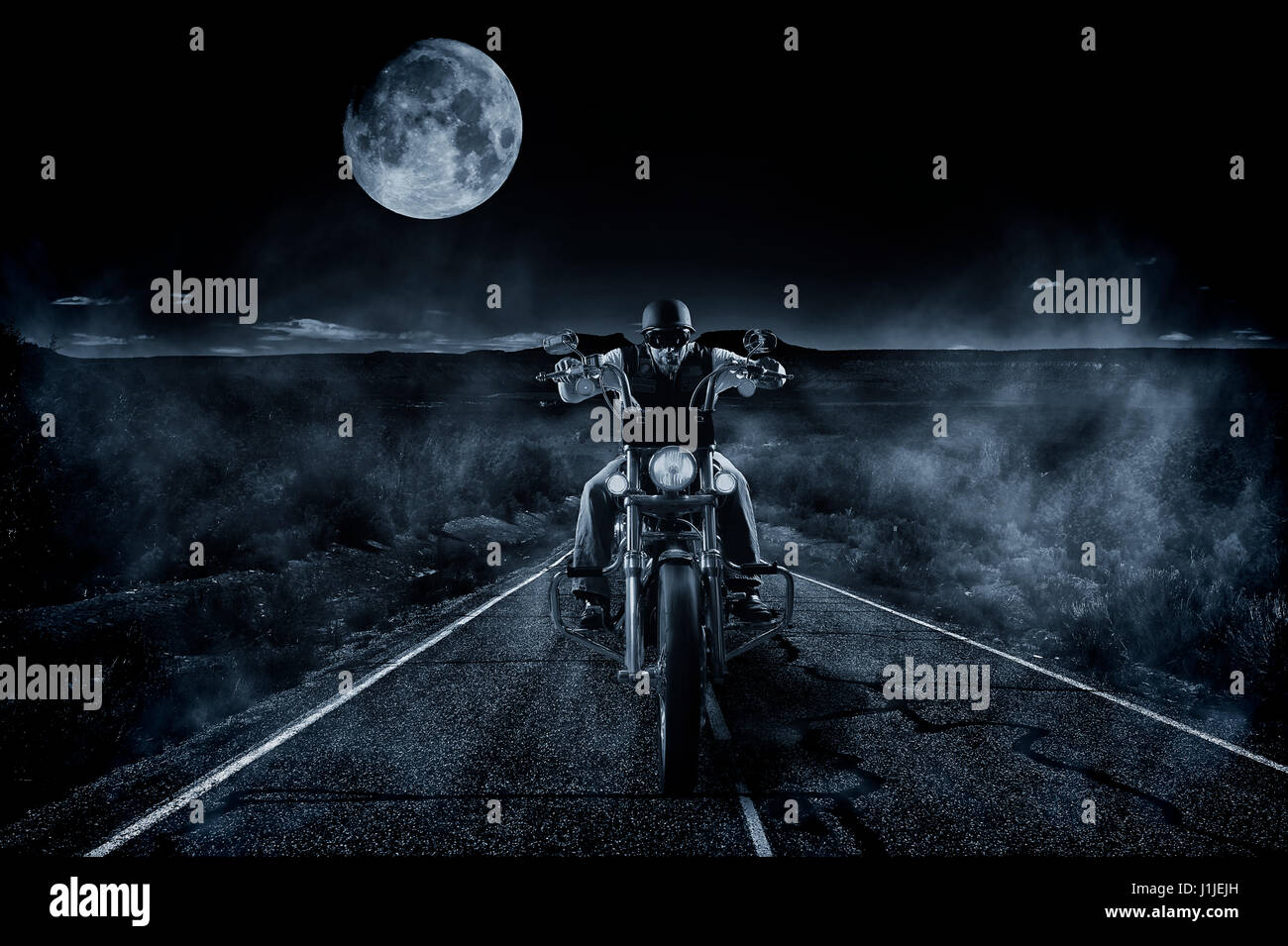 Lone rider cruising across a dark moonlit desert at night Stock Photo ...