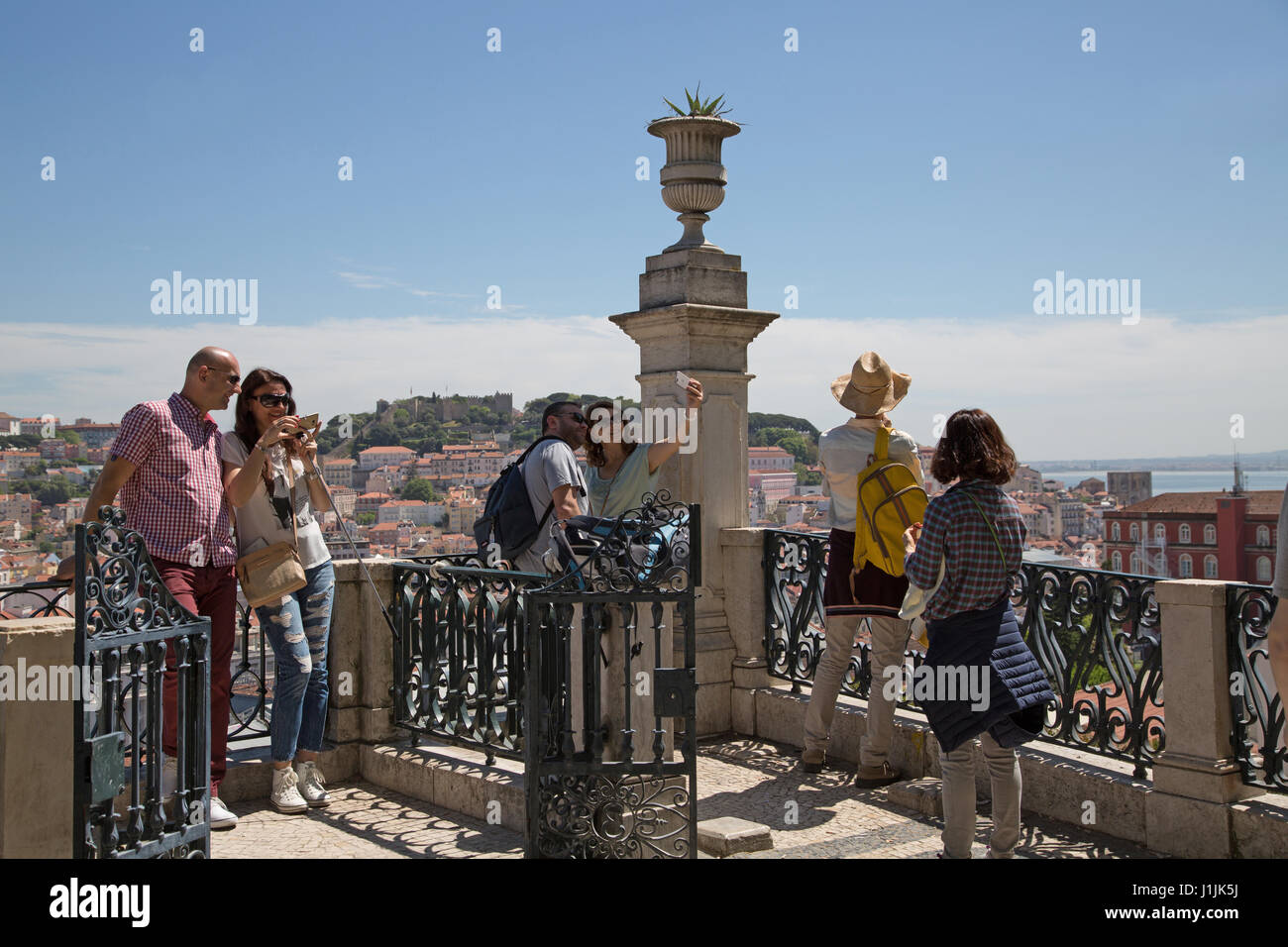 People taking selfies from terrace at Barrio Alto, Lisbon, Portugal. Stock Photo