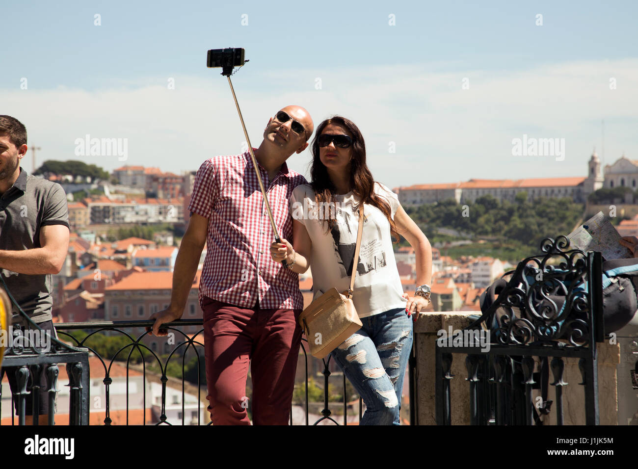 People taking selfies from terrace at Barrio Alto, Lisbon, Portugal. Stock Photo