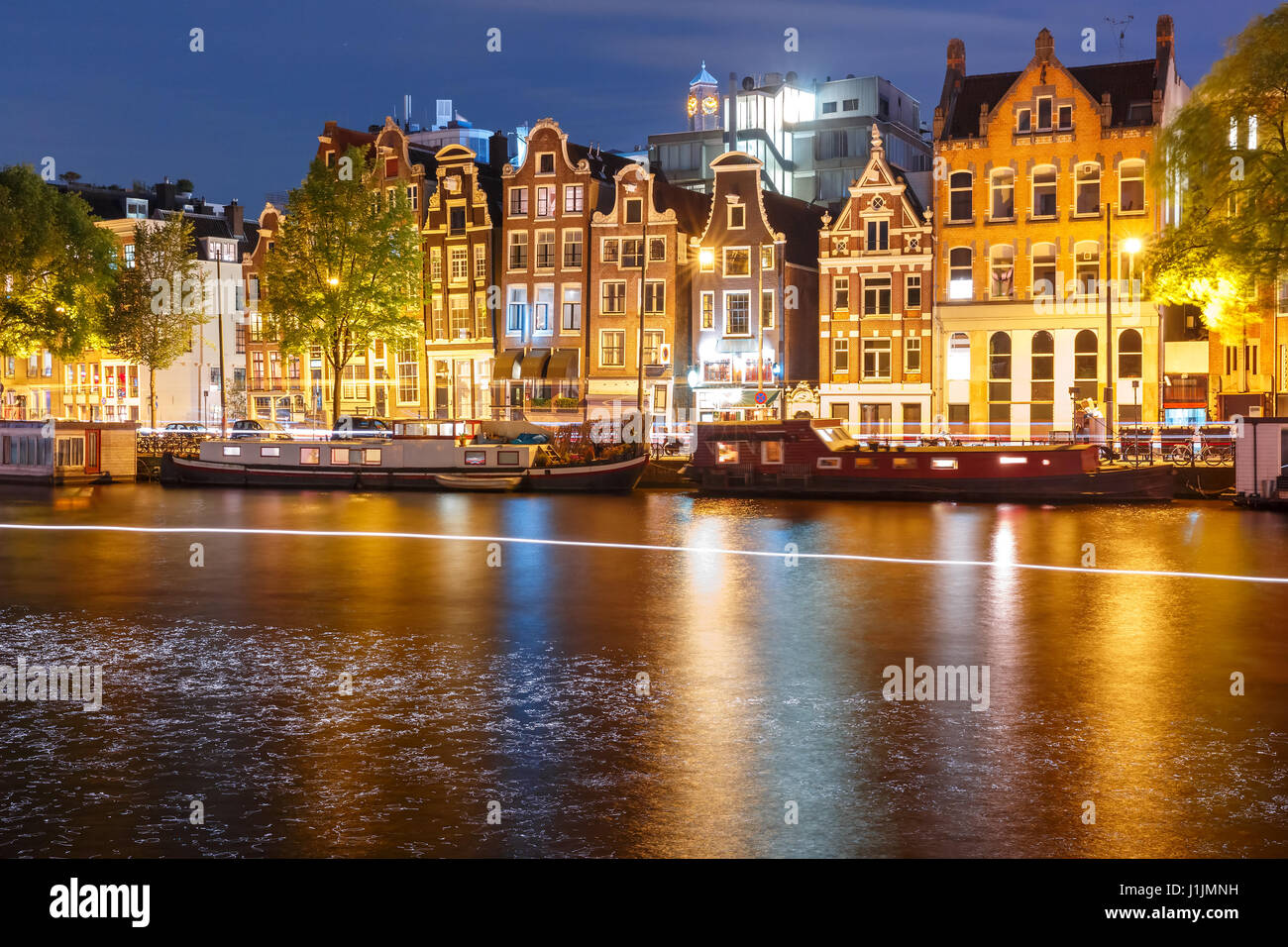 Night city view of Amsterdam canal with dutch houses Stock Photo
