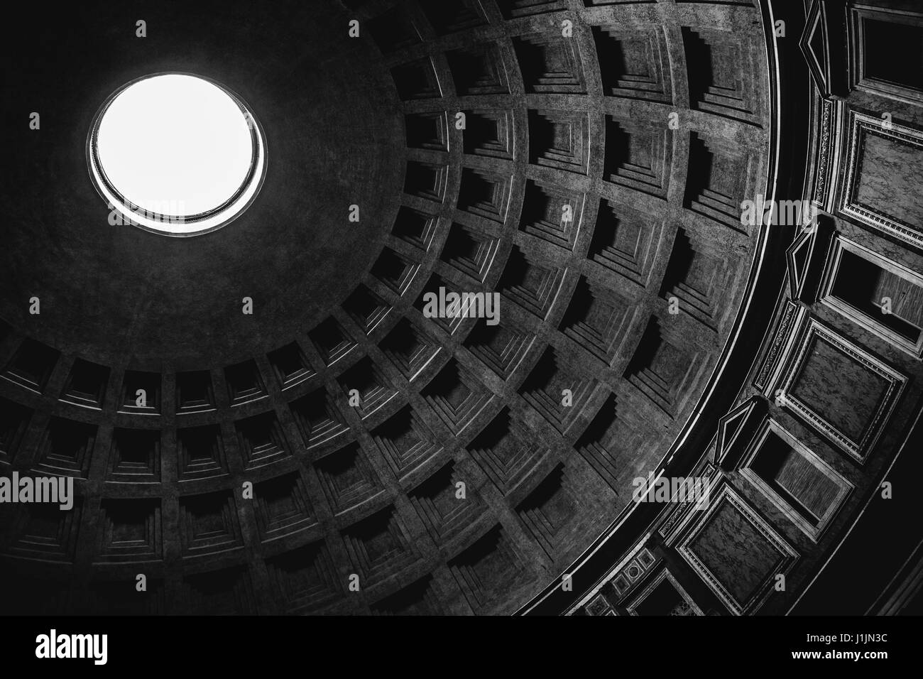 Inside view of the oculus (hole) and dome of the Pantheon in Rome in black and white. Stock Photo