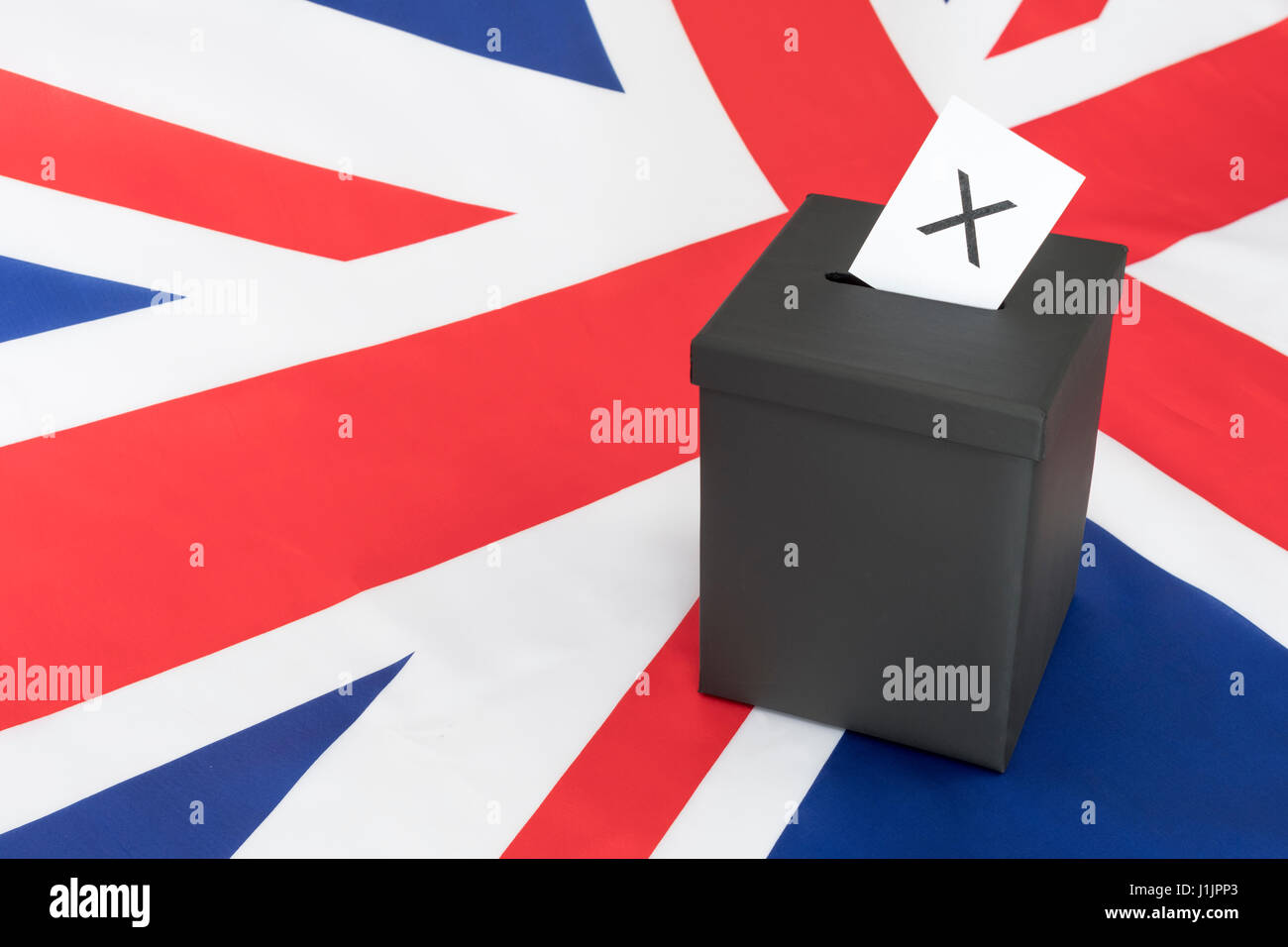 Replica black ballot box set against UK flag / Union Jack as metaphor for concept of British 2024 General Election - Brexit Election, Mock election. Stock Photo