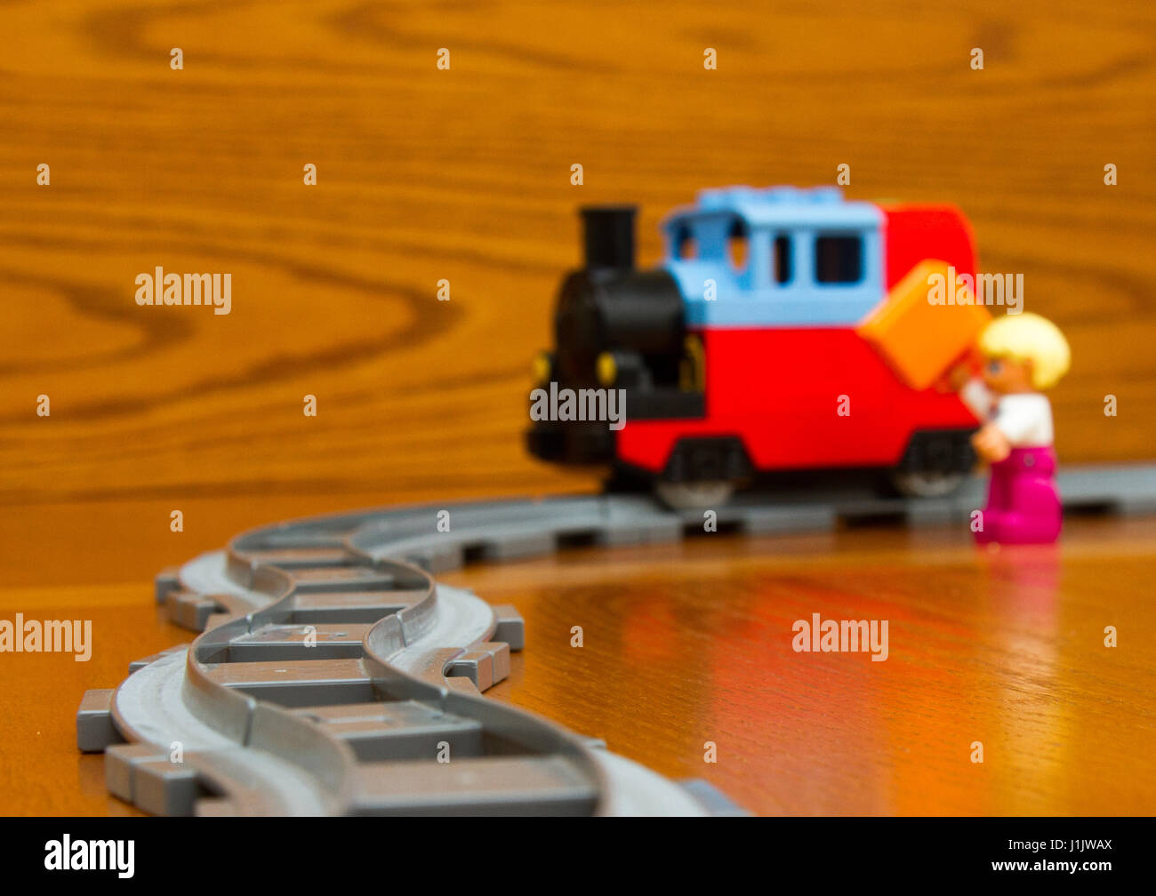 The toy train goes on rails. On a brown background Stock Photo - Alamy