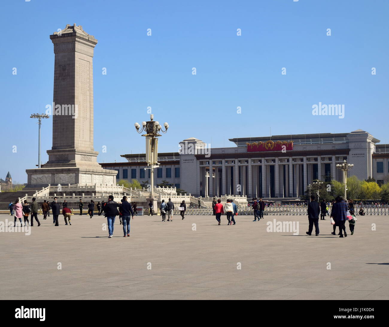 Beijing Tiananmen square landmarks: China National Museum behind the Monument to the People's Heroes, under a clear blue sky Stock Photo