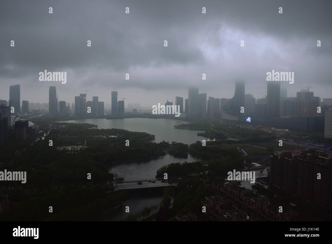 Storm clouds over city skyline and lake - Hefei, China Stock Photo