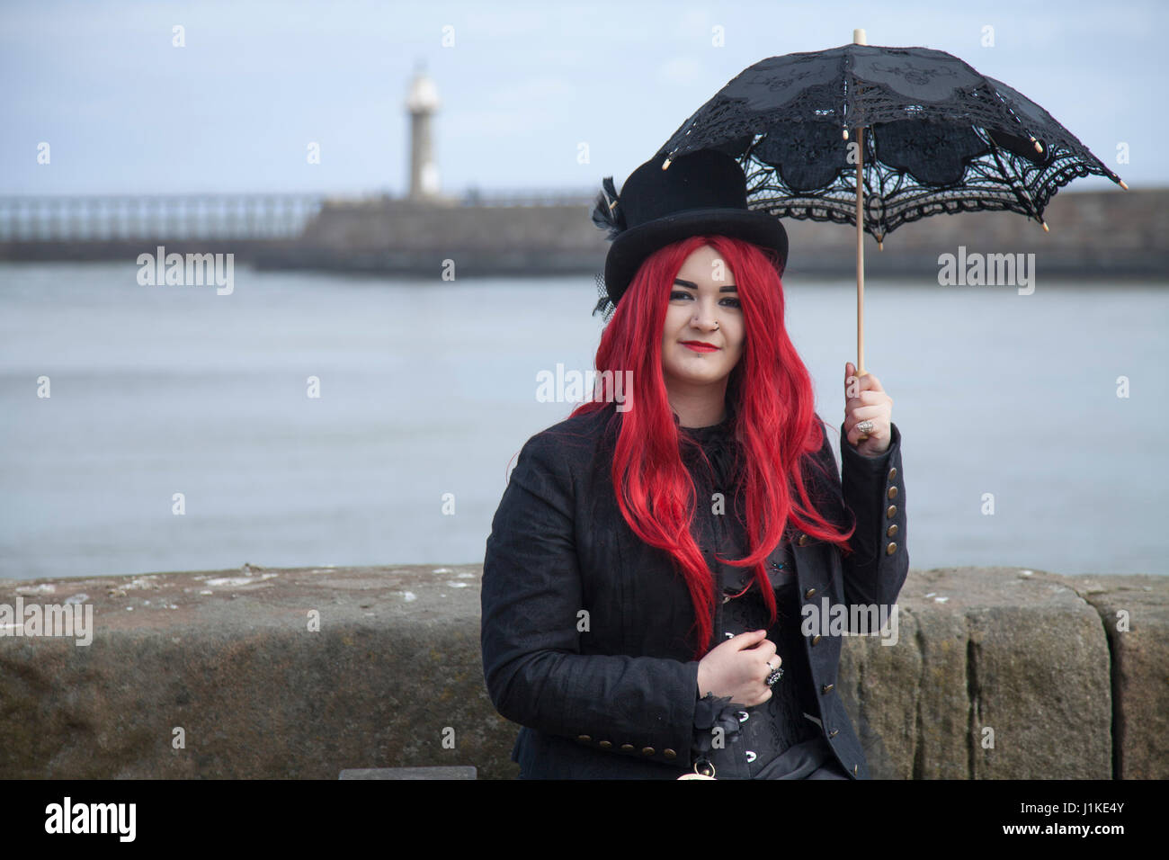 A young female Goth poses for photos at the Whiby quayside Credit: David Dixon/Alamy Live News Stock Photo