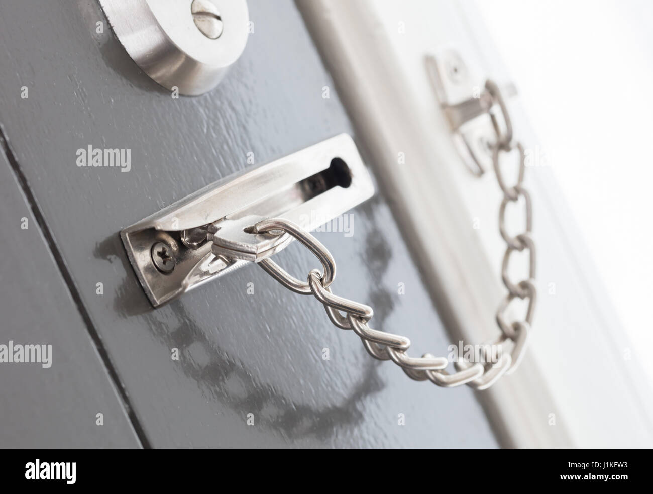 Door chain on a grey door, security measures Stock Photo - Alamy