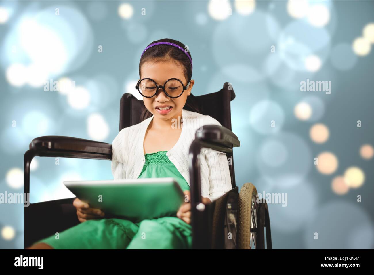 Digital composite of Girl in wheelchair using digital tablet Stock ...