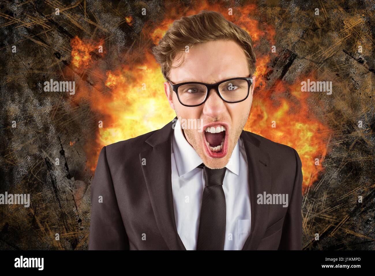 Digital composite of Digital composite image of angry businessman with fire in background Stock Photo