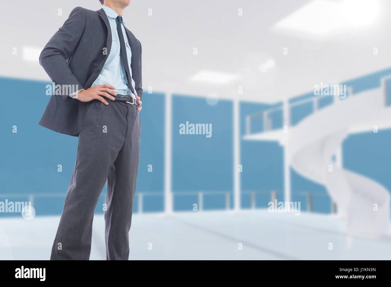 Digital composite of Midsection of businessman standing with hands on hips Stock Photo