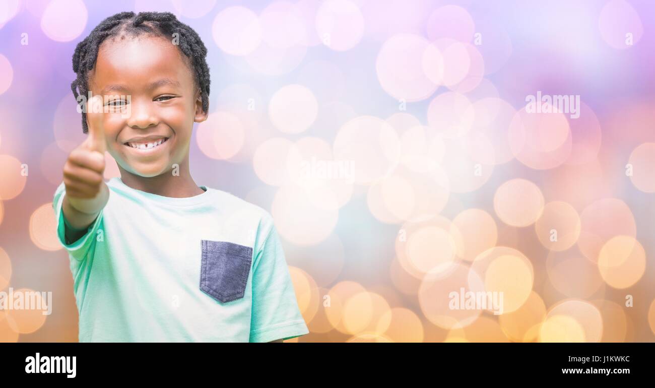 Digital composite of Happy girl showing thumbs up over bokeh Stock Photo