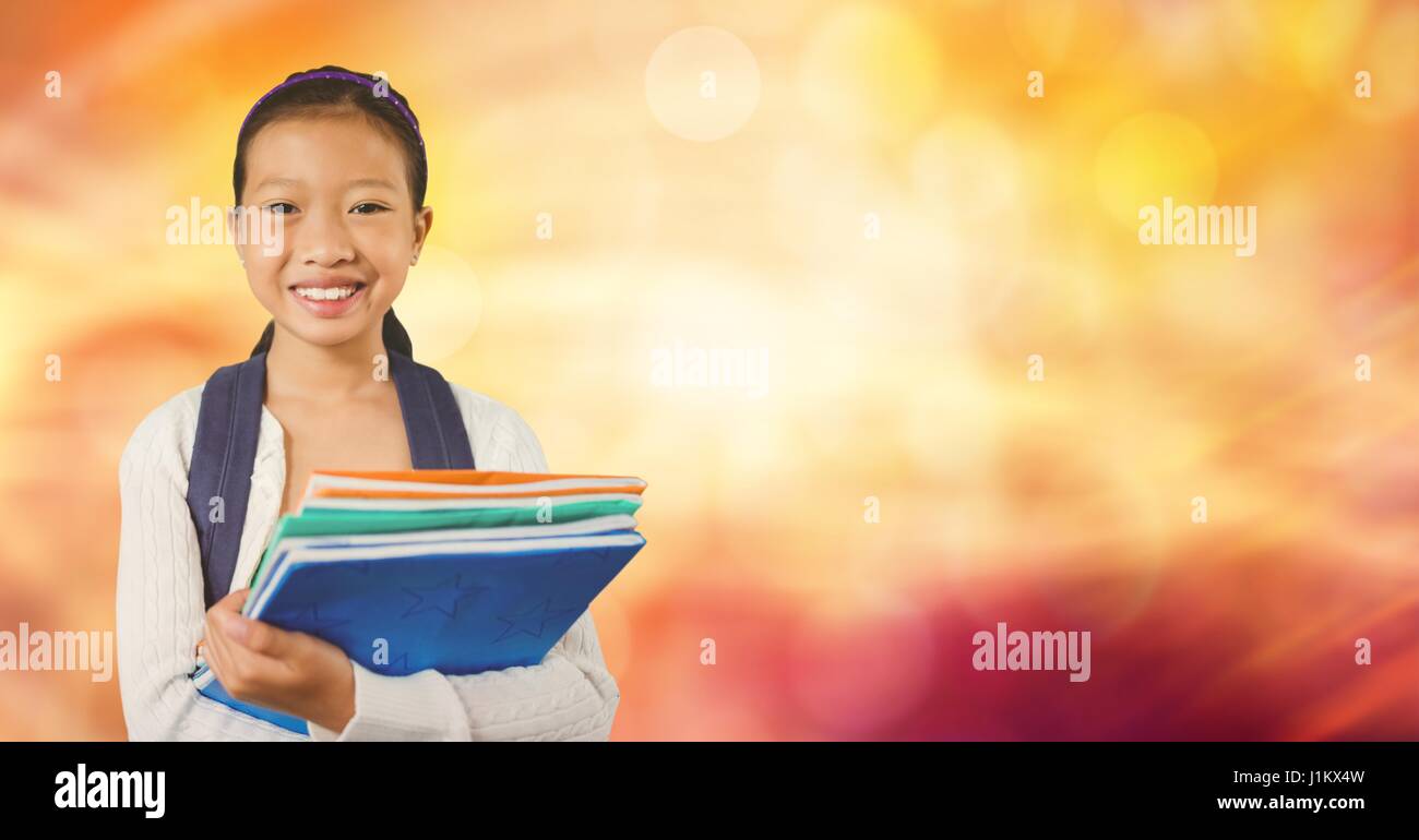 Digital composite of Happy school girl holding books Stock Photo - Alamy