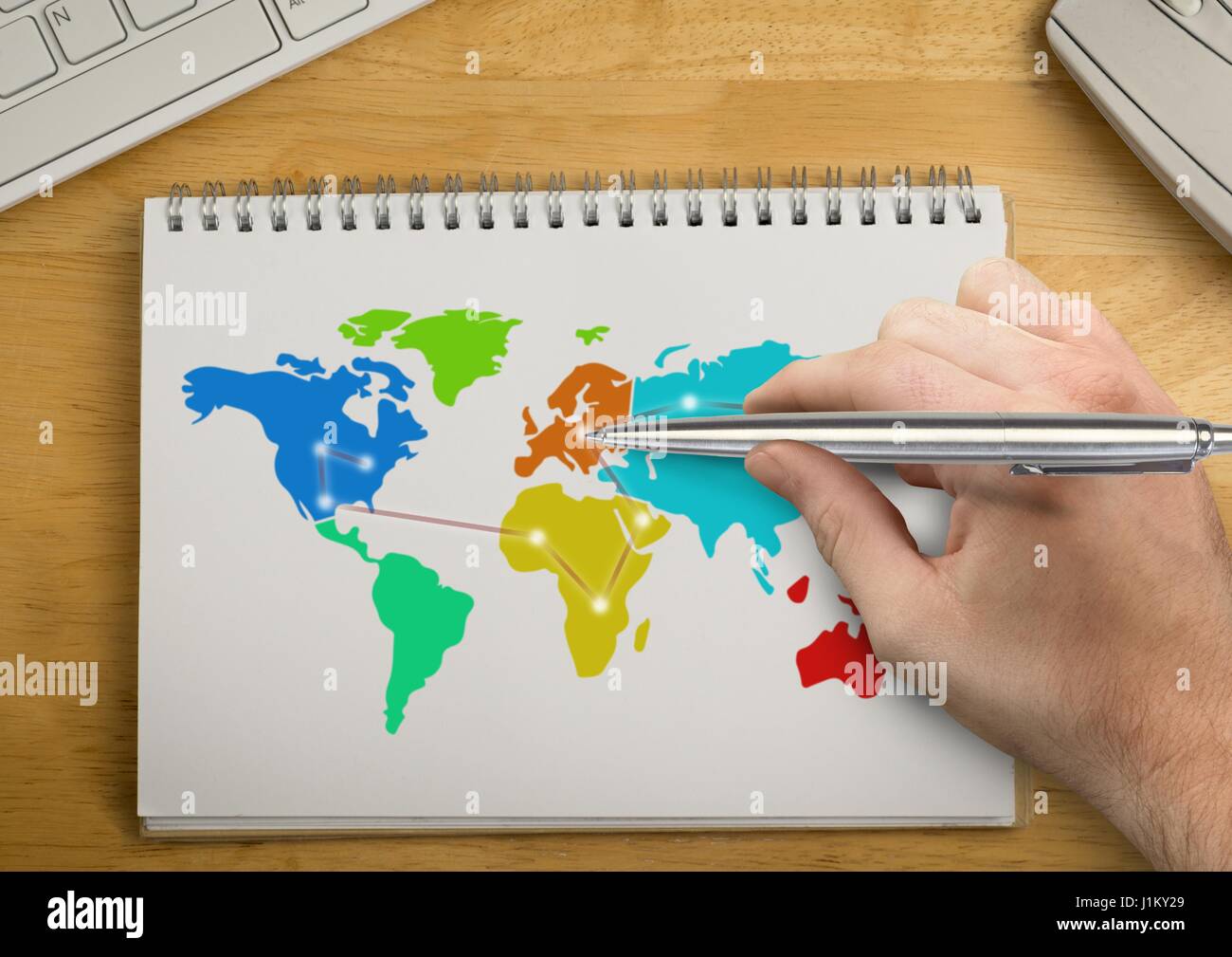 Digital composite of Hand writing with pen on Colorful Map on a notepad ...