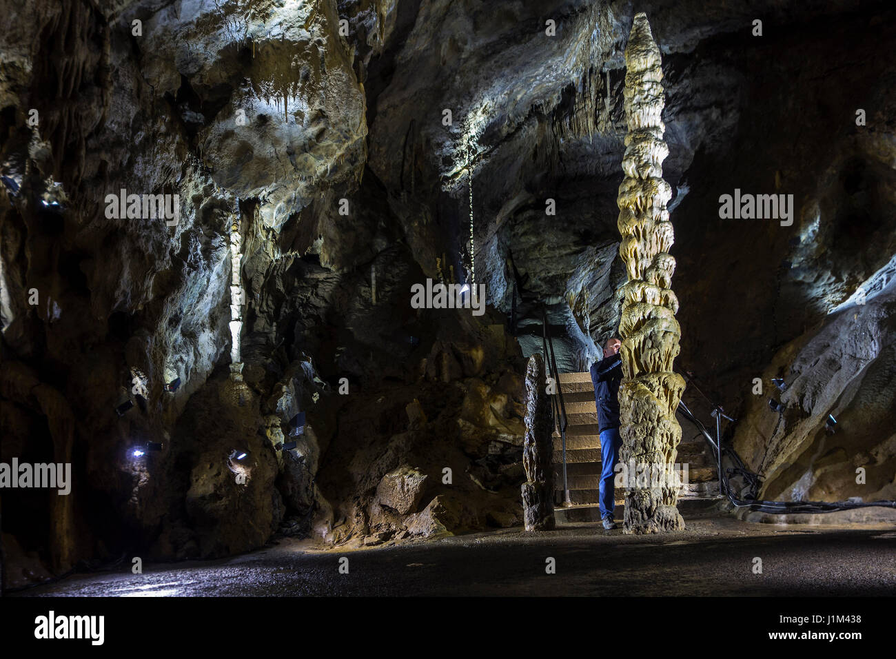 Tourist looking at big stalagmite in the Caves of Han-sur-Lesse / Grottes de Han, Belgian Ardennes, Belgium Stock Photo