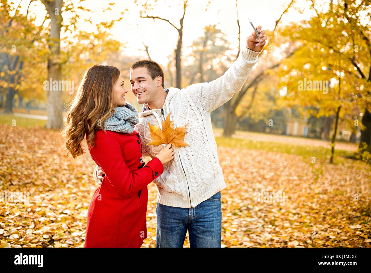 Couple in love taking selfie in forest Stock Photo - Alamy
