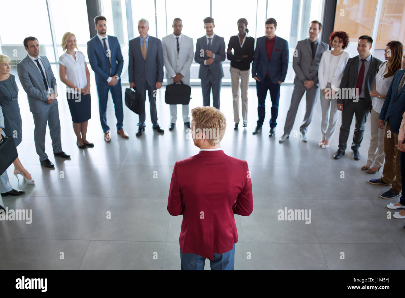young leader standing in front of his successful business team Stock ...
