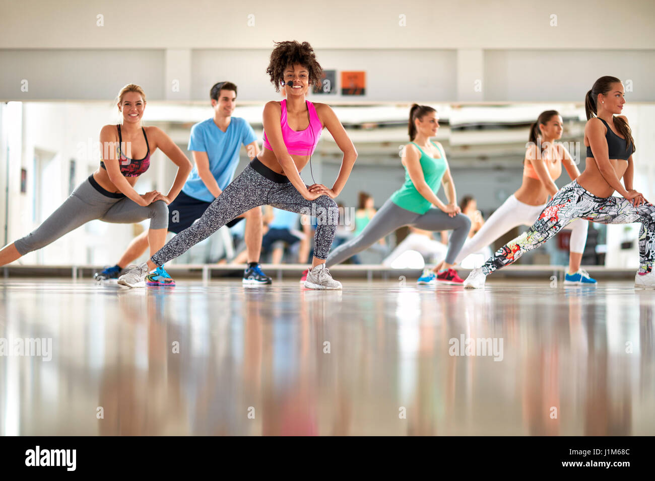 Young black curly trainer with group training aerobic at gym Stock Photo