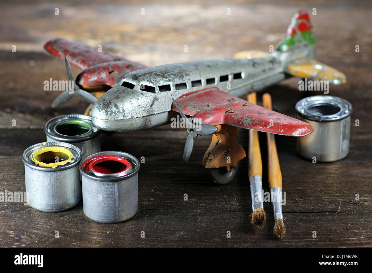 antique tin toy plane under restoration Stock Photo