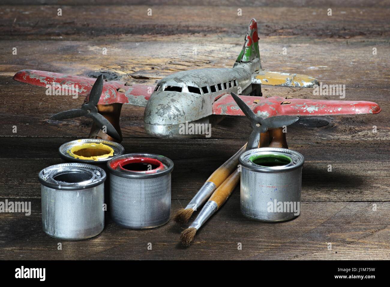 antique tin toy plane under restoration Stock Photo