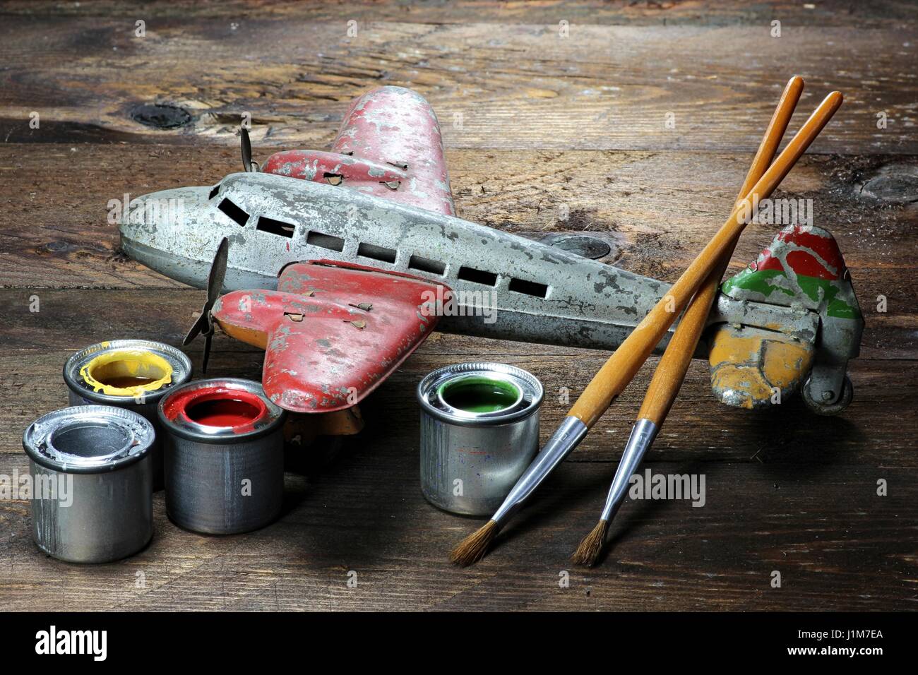 antique tin toy plane under restoration Stock Photo